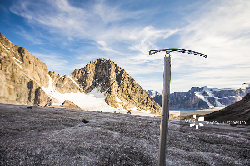 冰川和山脉前的登山者冰镐图片素材