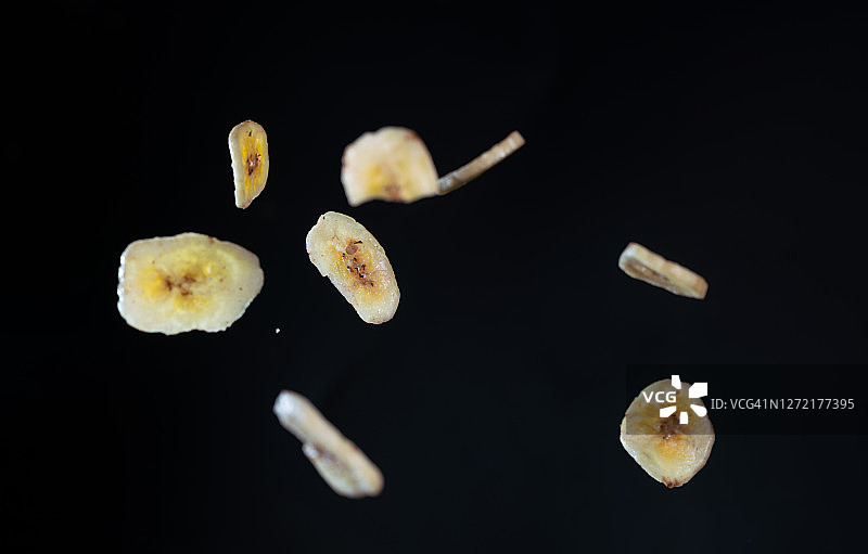 高速同步拍摄的飞在空中的炸香蕉片图片素材