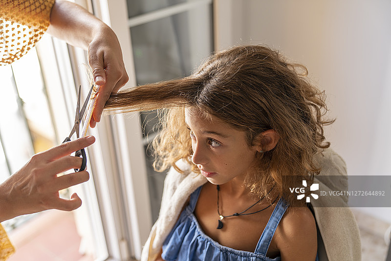 母亲在家给小女儿剪头发图片素材