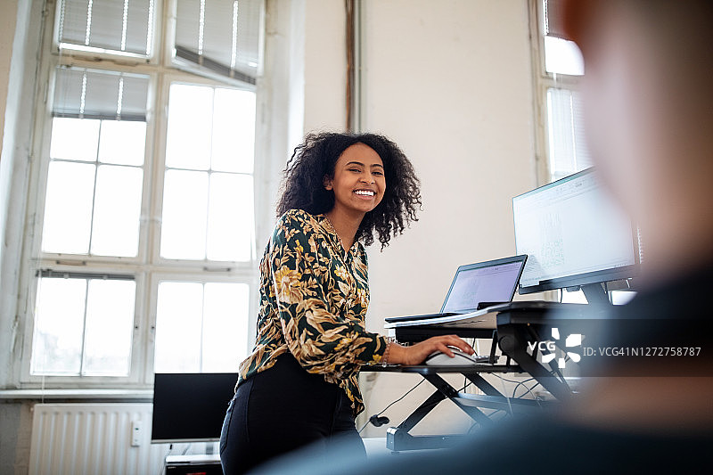 微笑的女人在办公室讨论工作图片素材