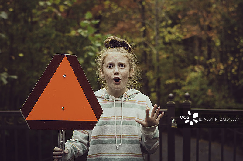 女孩手持红色三角形标志图片素材