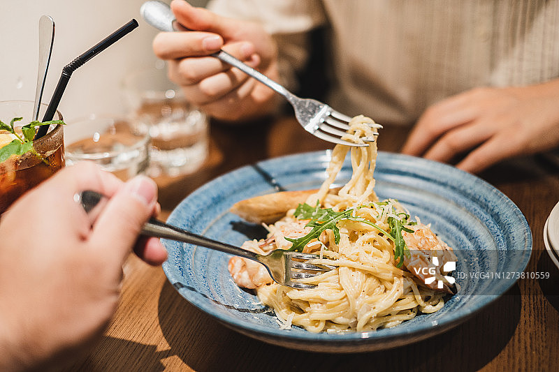 在餐厅分享意面的情侣图片素材