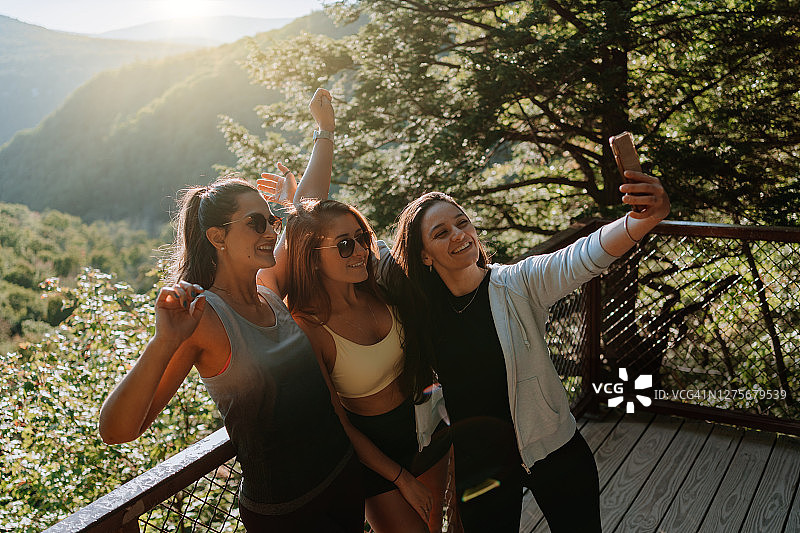 朋友们在有瀑布的山上徒步图片素材