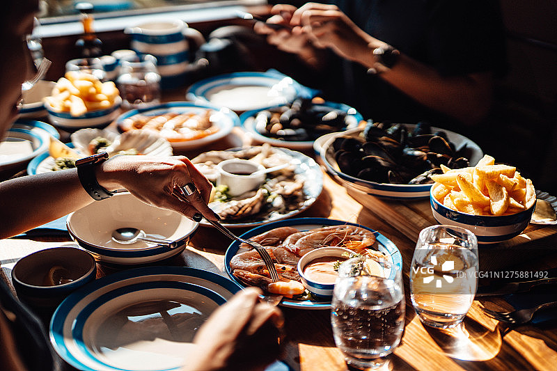 朋友们在餐厅享用新鲜海鲜图片素材