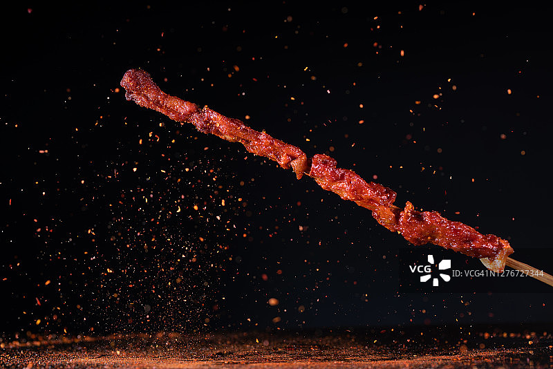 炸羊肉串与飞在空中的红辣椒图片素材