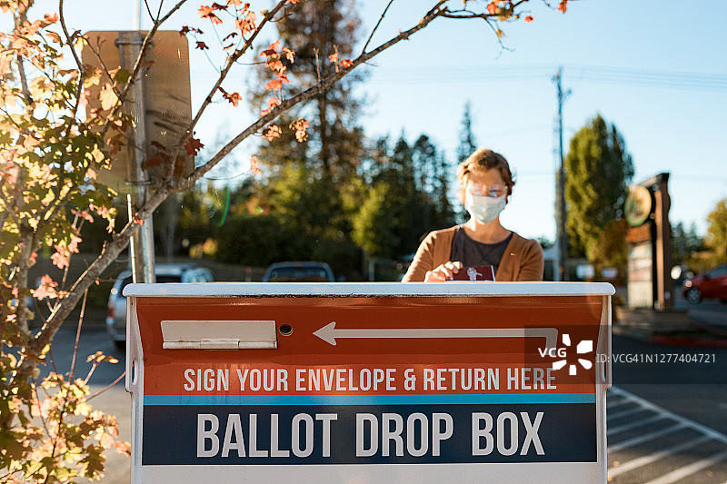 女人投入缺席邮寄选票图片素材