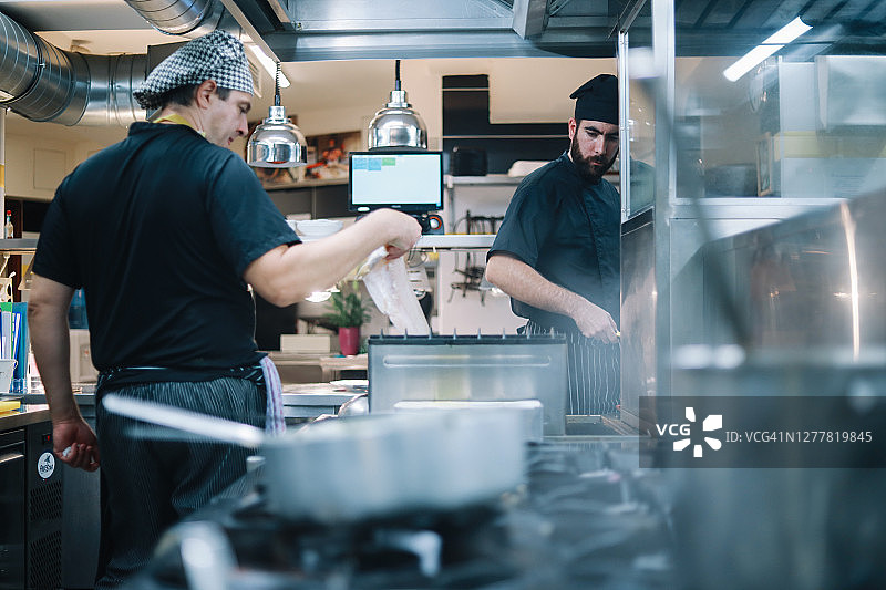 餐厅厨房：厨师们正在备餐图片素材