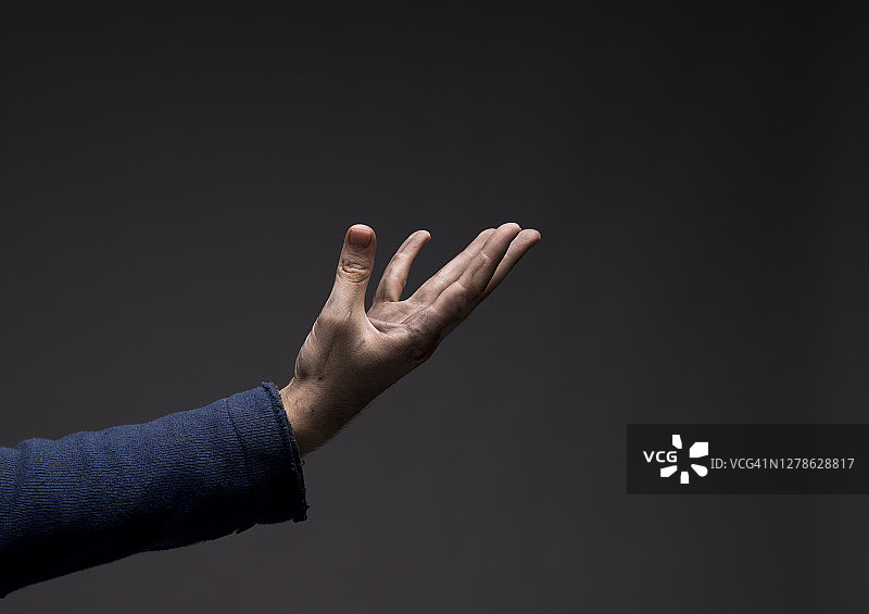 工人的手在黑暗背景下拿着隐形物品图片素材