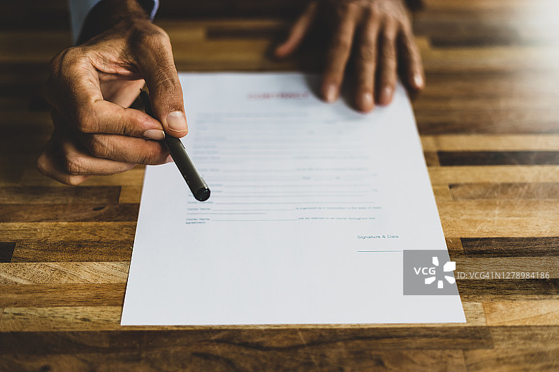 男人在合同上递笔图片素材