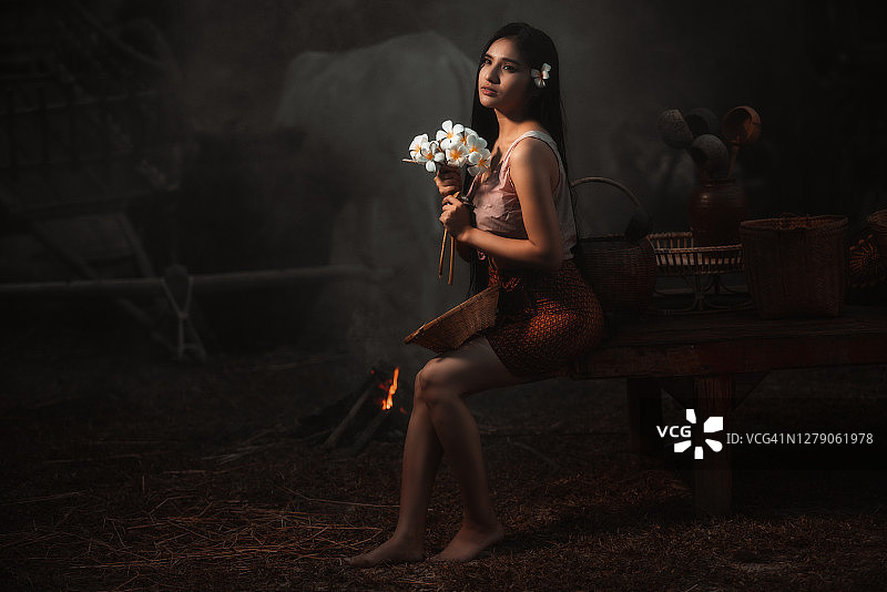 手持白色鲜花的漂亮泰国女人图片素材