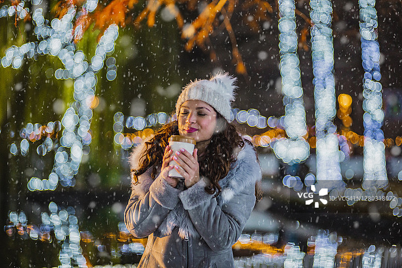 年轻女人在户外享用热饮图片素材
