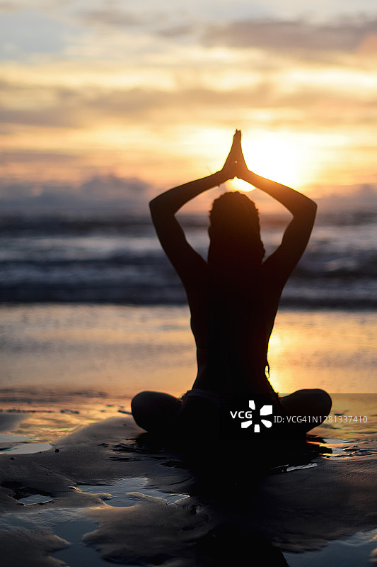 日落时分，女子做瑜伽的轮廓图片素材