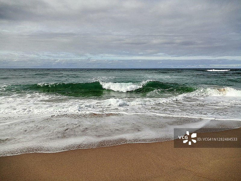 英国苏格兰萨瑟兰Sandwood海湾的碧绿色海浪拍打着海滩图片素材