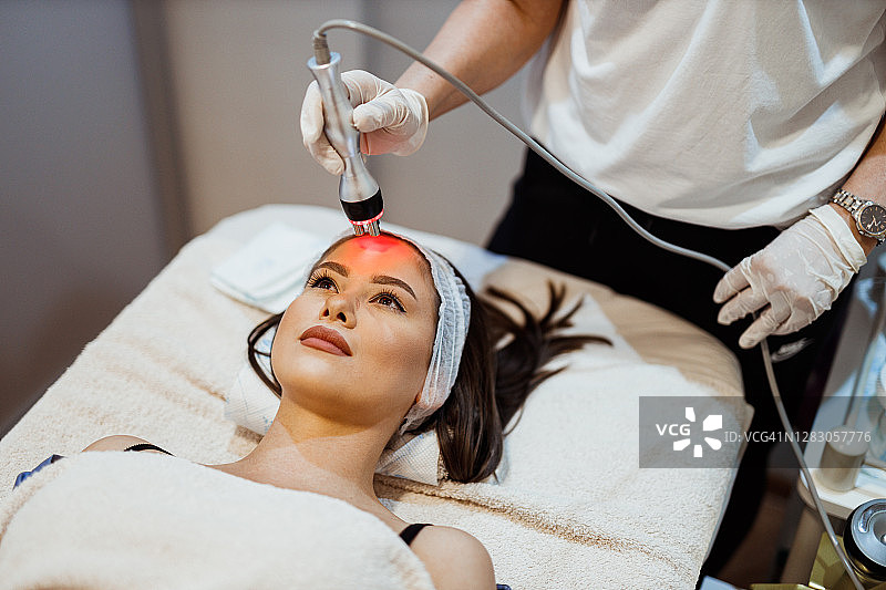 女人在美容诊所接受面部护理图片素材