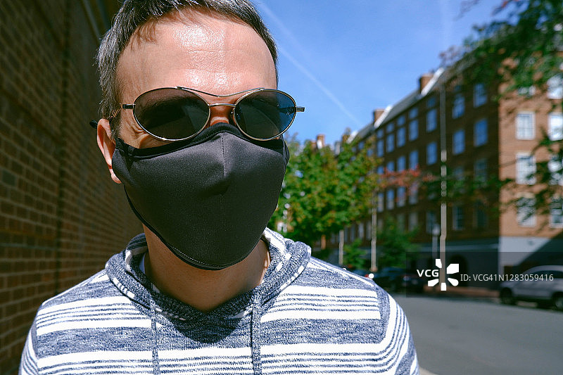 男人户外散步戴着防护口罩图片素材