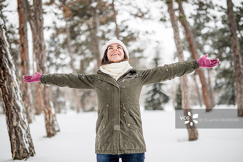 女人在下雪天张开双手图片素材