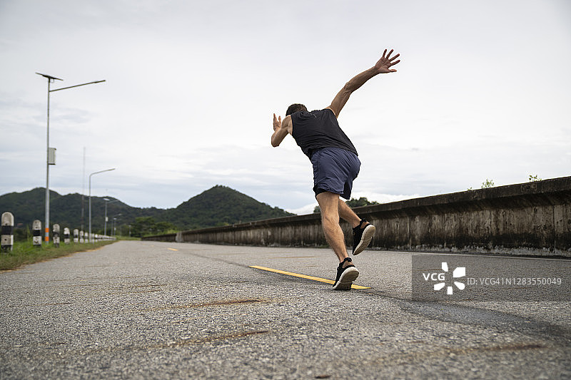 男人在跑道上跑步训练的脚部特写图片素材