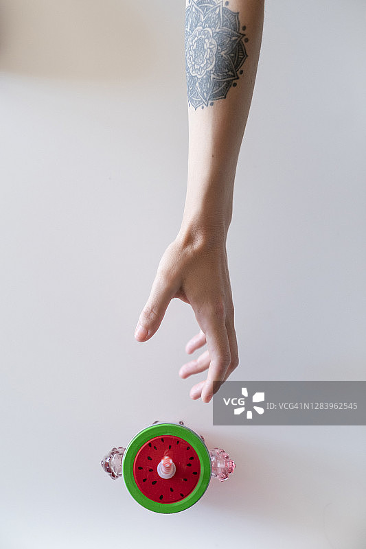 特写：女人伸手拿桌上的容器图片素材