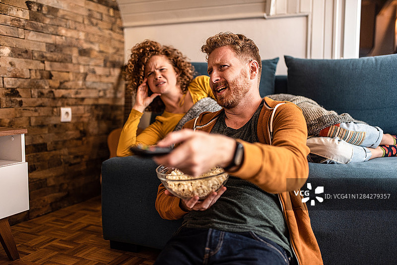 厌恶的年轻夫妇在看电影图片素材