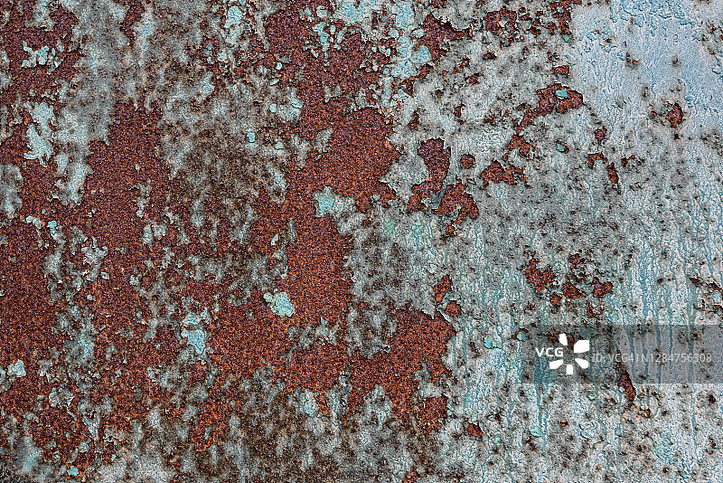 蓝色油漆下的锈蚀表面图片素材