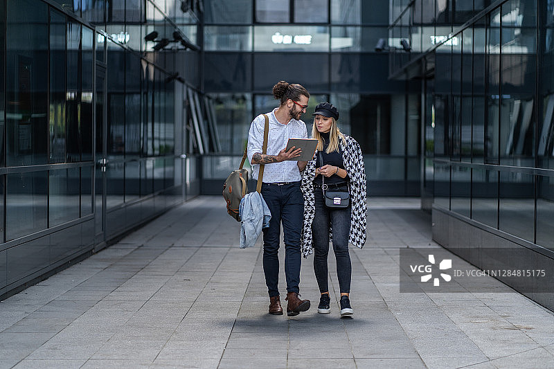 两位年轻同事在旅途中讨论工作图片素材