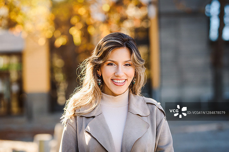 城市中美丽的年轻白人女子微笑的肖像照片图片素材