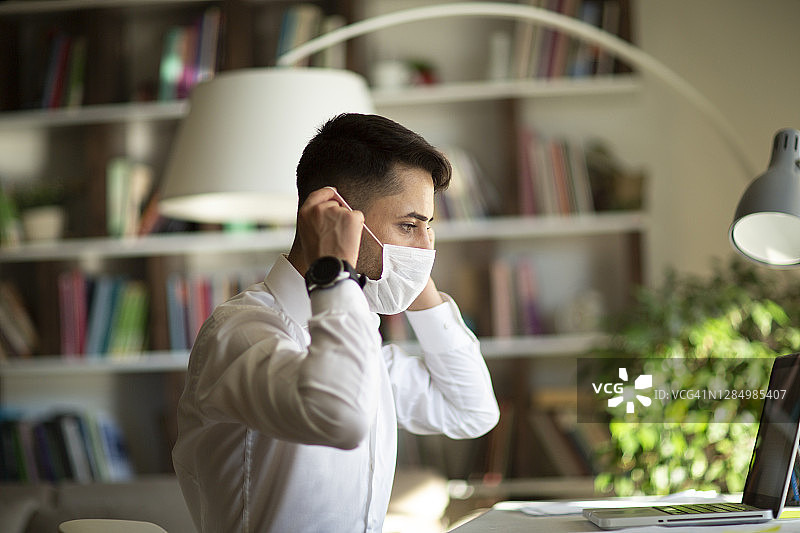 在办公室戴医用口罩的男人图片素材