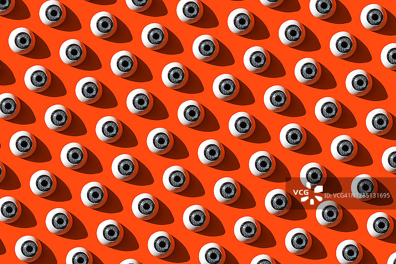 红色背景上的重复眼睛图案图片素材