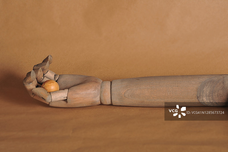 手臂与棕色背景上的球体图片素材