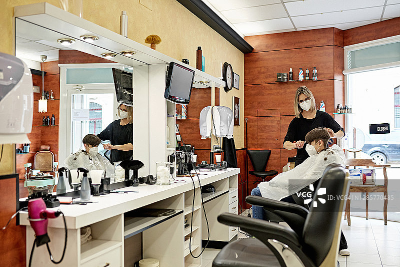 新冠疫情期间正在理发的女理发师图片素材