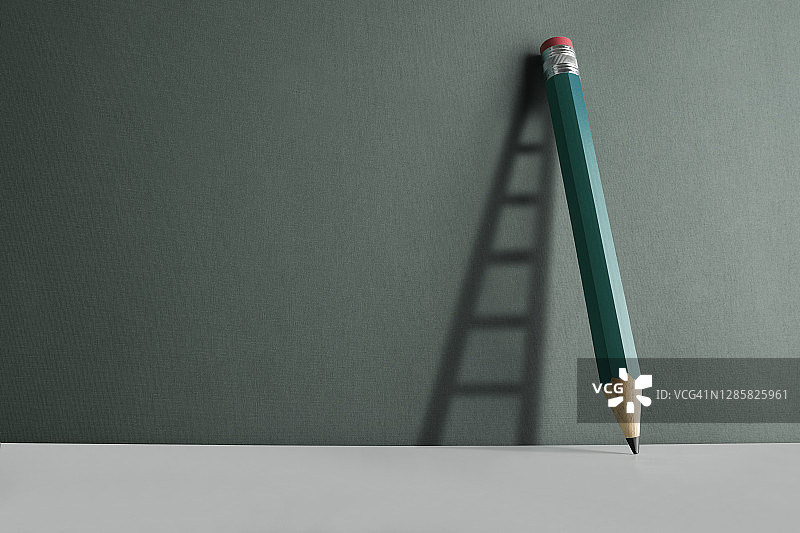 靠在墙上的铅笔与墙上的梯子阴影图片素材
