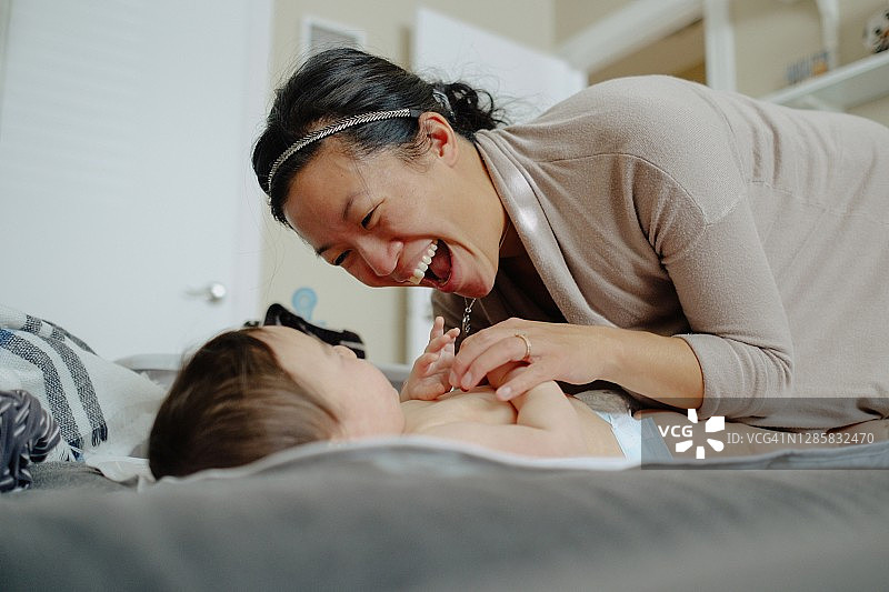 母亲给婴儿换尿布图片素材