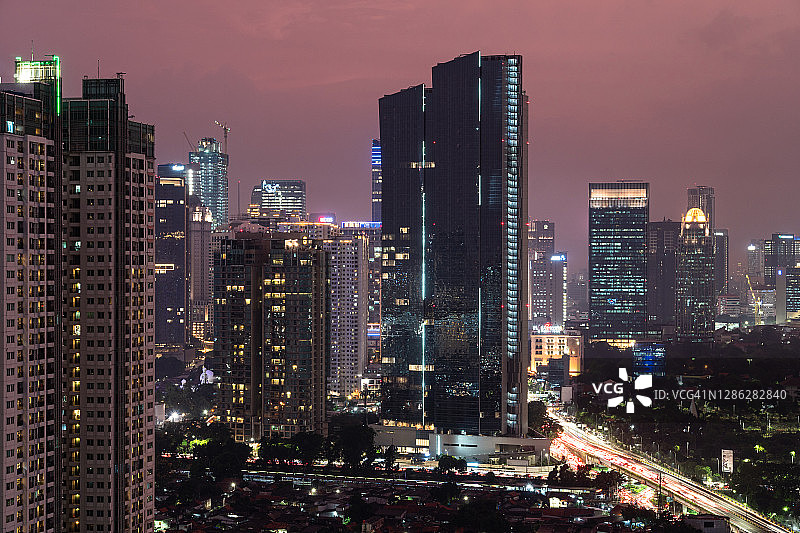 雅加达市中心高层住宅楼和办公楼的暮色图片素材