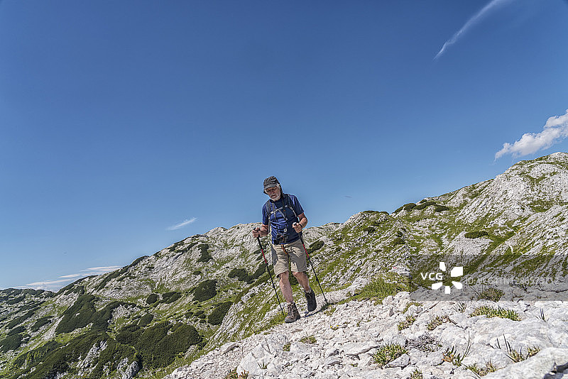 男人在蓝天下徒步高山图片素材