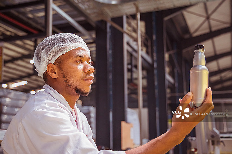 赞比亚工厂工人在检查瓶子图片素材