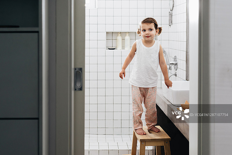 幼儿站在浴室的梯子上图片素材