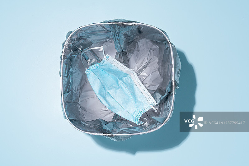 丢弃在垃圾桶中的口罩图片素材