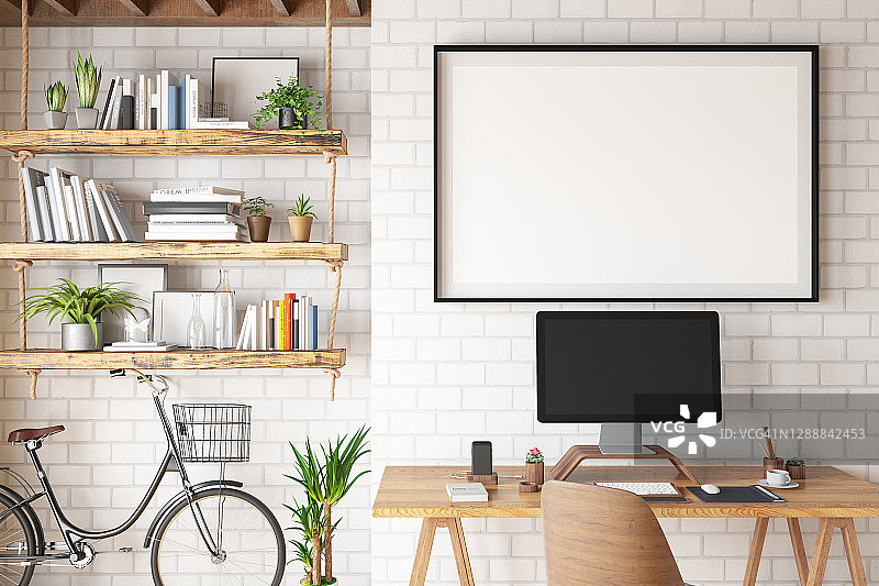 配备电脑和空白相框的家庭办公室概念图片素材