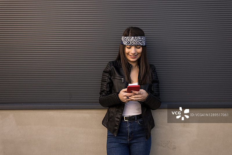 在城市里发短信的城市年轻女人图片素材