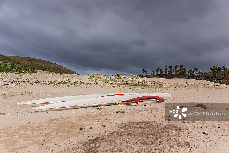 复活节岛阿纳凯纳海滩上的独木舟和摩艾石像图片素材