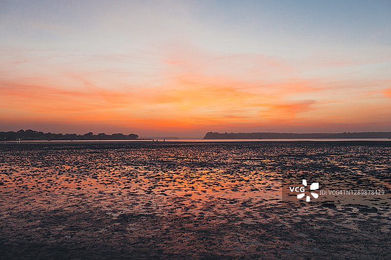 低潮时海滩上的壮丽日落图片素材