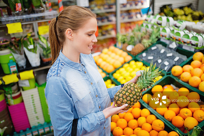 年轻女人在当地市场购物图片素材