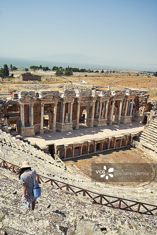 戴帽子的女人参观土耳其棉花堡希拉波利斯古剧院遗址图片素材