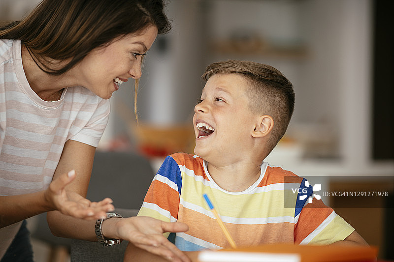 母亲在家辅导儿子做作业图片素材