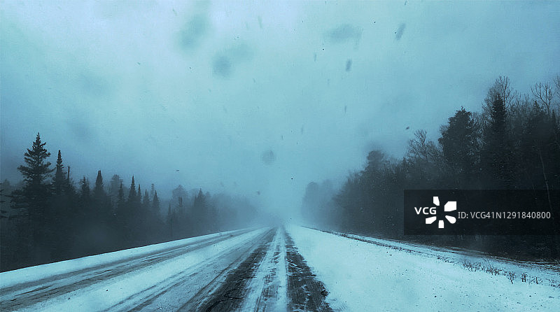 冬天在雪地行驶时，从车窗向外看视线受阻图片素材