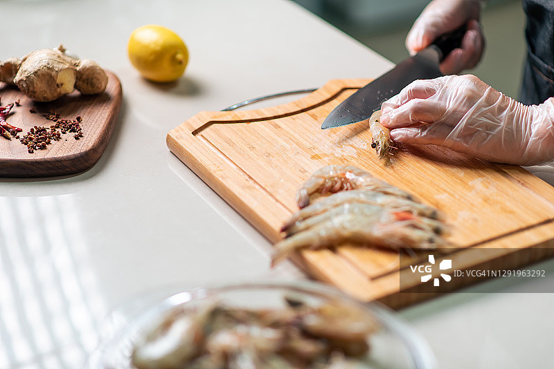 女人在厨房剥虾并清理以备烹饪图片素材