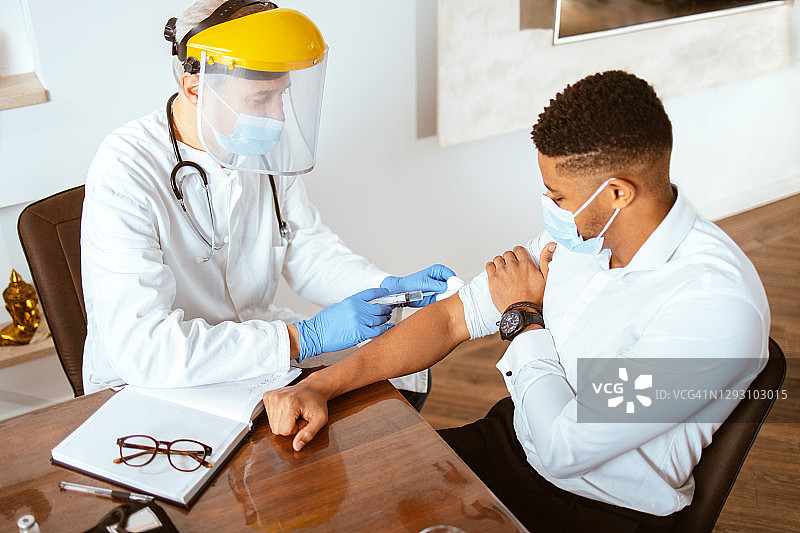 医生为一名非裔美国青年男子接种疫苗图片素材