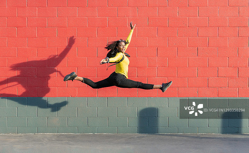 跳跃和做体操动作的非裔美国女孩图片素材