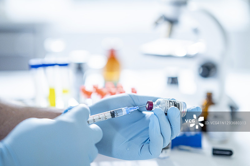 科学家测量COVID-19疫苗的剂量图片素材