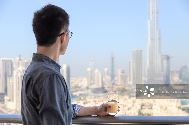 在迪拜欣赏城市天际线的男人们图片素材